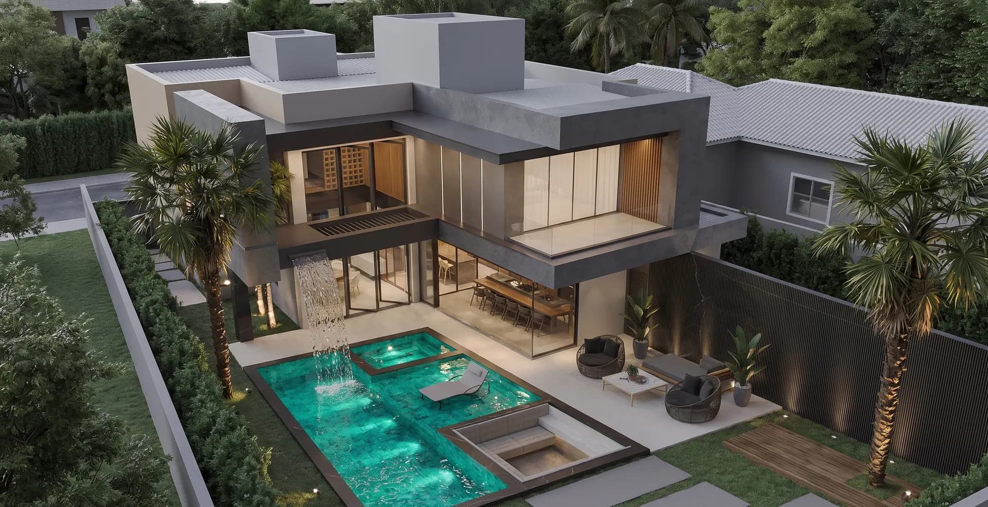 Aerial view of the villa's rear garden, with a turquoise pool, sheet waterfall and outdoor lounge beside the glazed living room